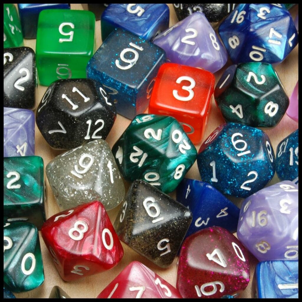 Close up view of an assortment of polyhedral dice in a variety of colors.
