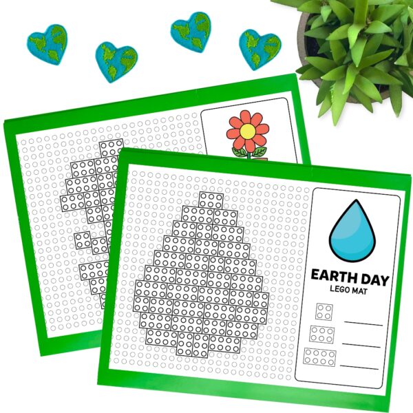 Mockup with two build mats. One with a flower and one a drop of water. Printable mats laying on green paper.